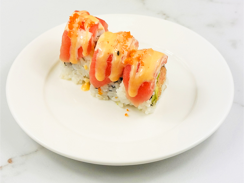 Red Bird sushi roll topped with tuna and spicy mayo, closeup