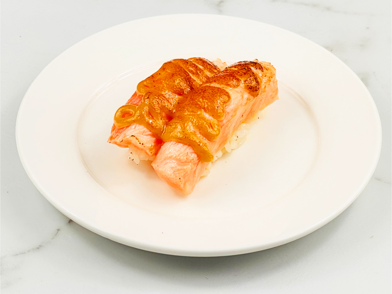 Seared salmon nigiri with mayo glaze, closeup